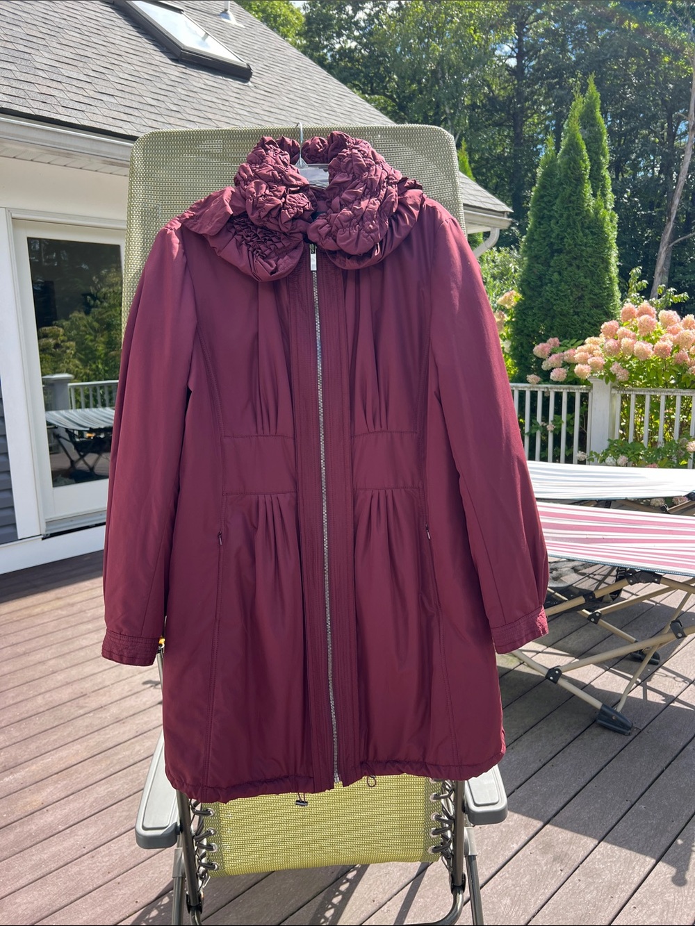 Gorgeous wind resistant coat with beautiful lines and details with a hidden hood